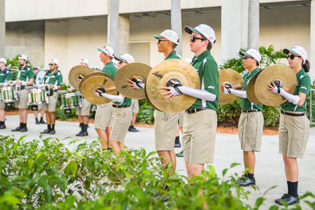 Students perform with cymbals.