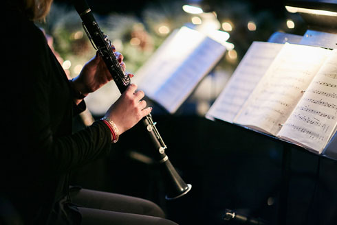 A musician performs on a clarinet.