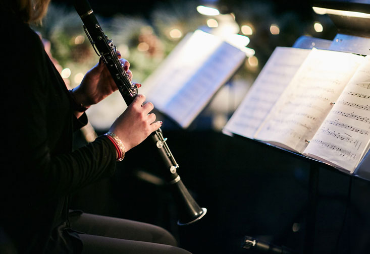 A musician performs on a clarinet.