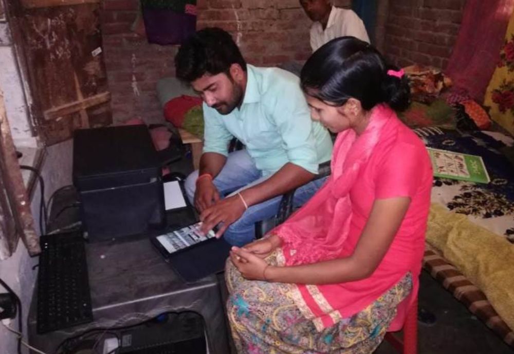 Indian people sitting and using a tablet for microentrepreneurship.