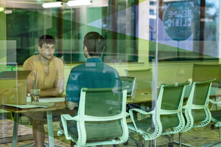 Two people talking at a conference table