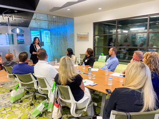 Group listening to speaker while sitting at a conference table