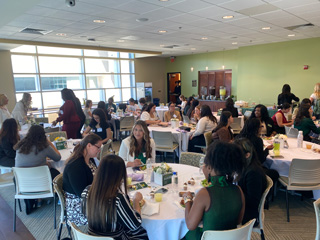 Women eating/talking at luncheon