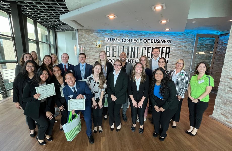 Group posing in front of Bellini Center sign