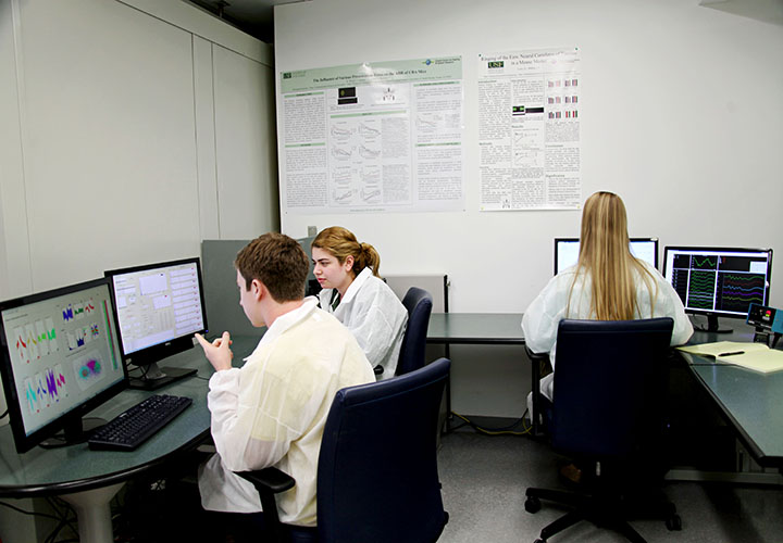 Three persons working in a lap on computers