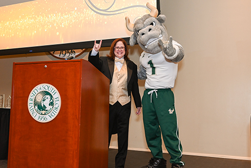 Kim Read on stage with USF's mascot, Rocky