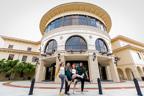 students in front of the main building on the USF Sarasota-Manatee campus