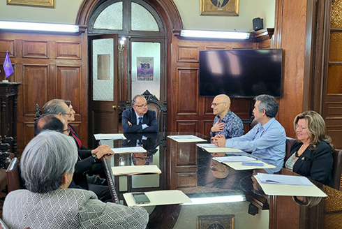 galea speaks to a room of individuals sitting at a table