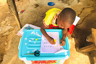 A child works on a worksheet