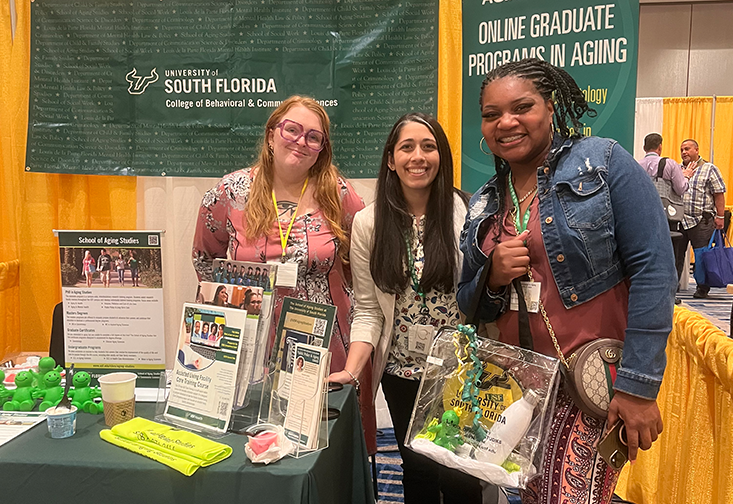 Jessica VanderWerf and Nasreen Sadeq take a photo with a conference attendee