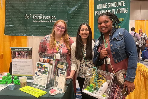 Jessica VanderWerf and Nasreen Sadeq take a photo with a conference attendee