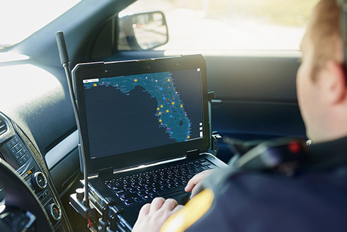 Law enforcement officer viewing a map on a laptop