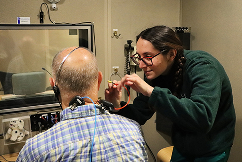 A student conducts a hearing exam