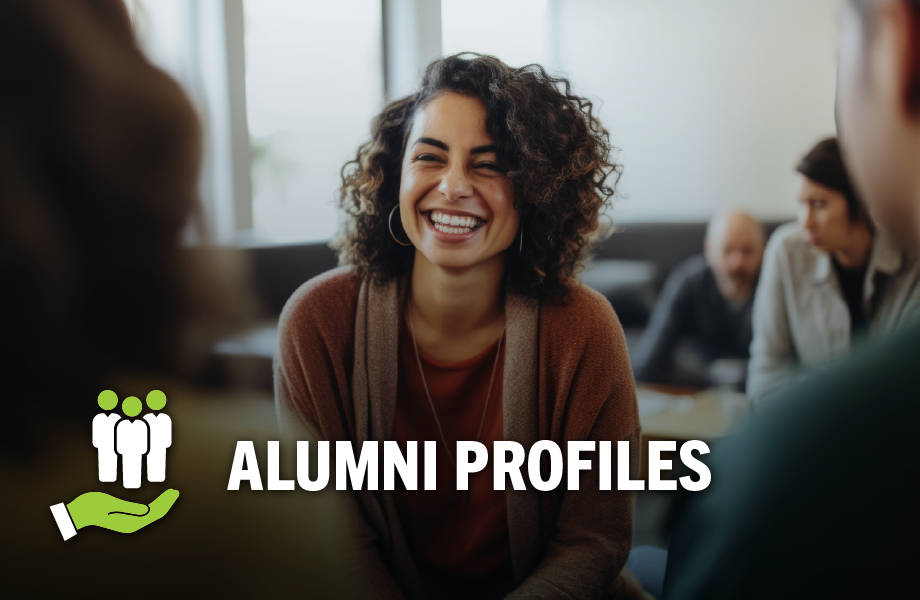 A smiling person seen from between the shoulders of two others, with text reading "Alumni Profiles"