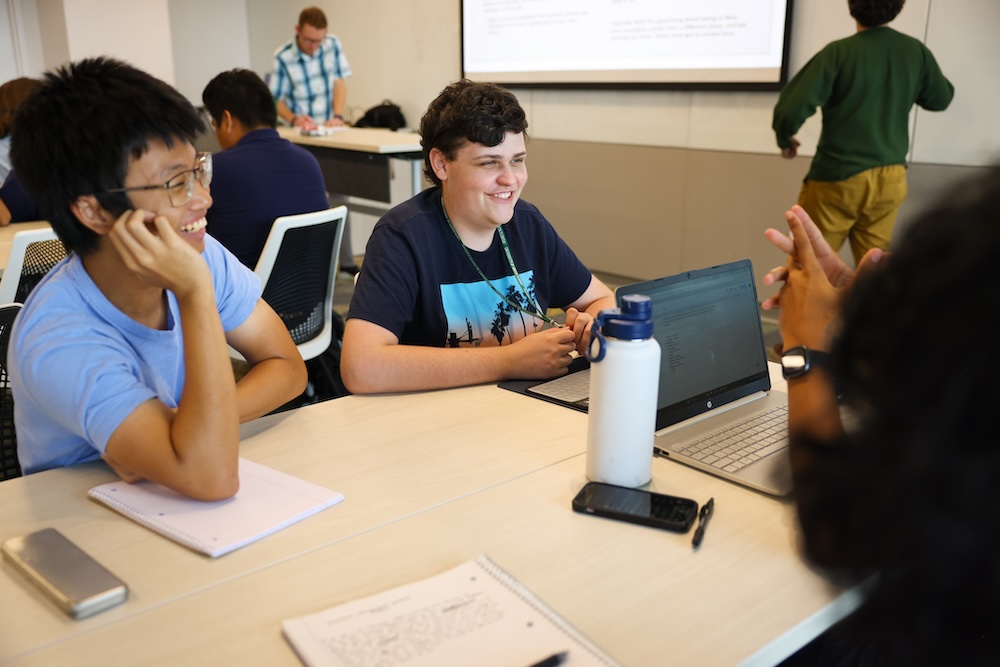 Students sit around a table in the classroom