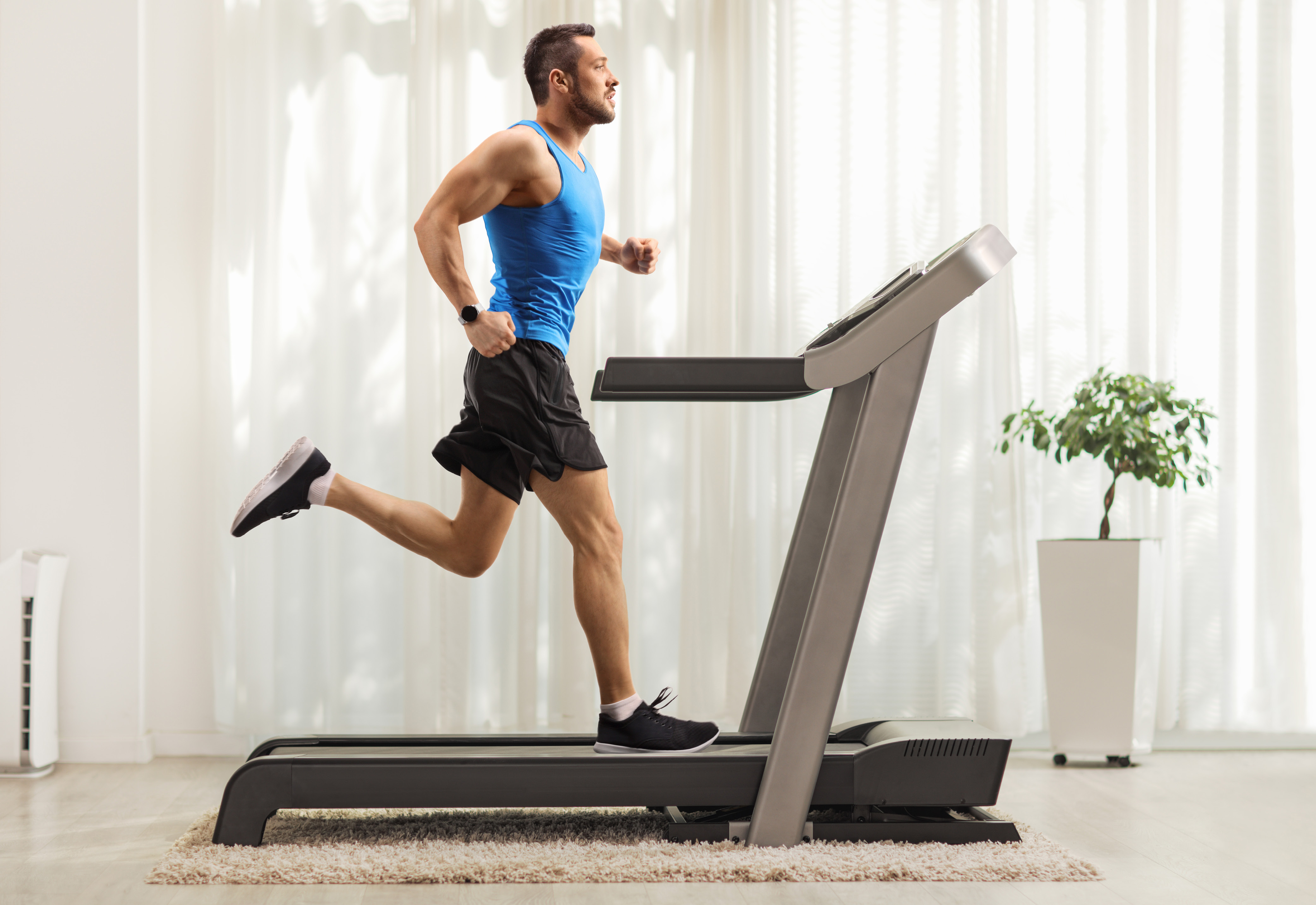 A man wearing athletic clothing running on a treadmill