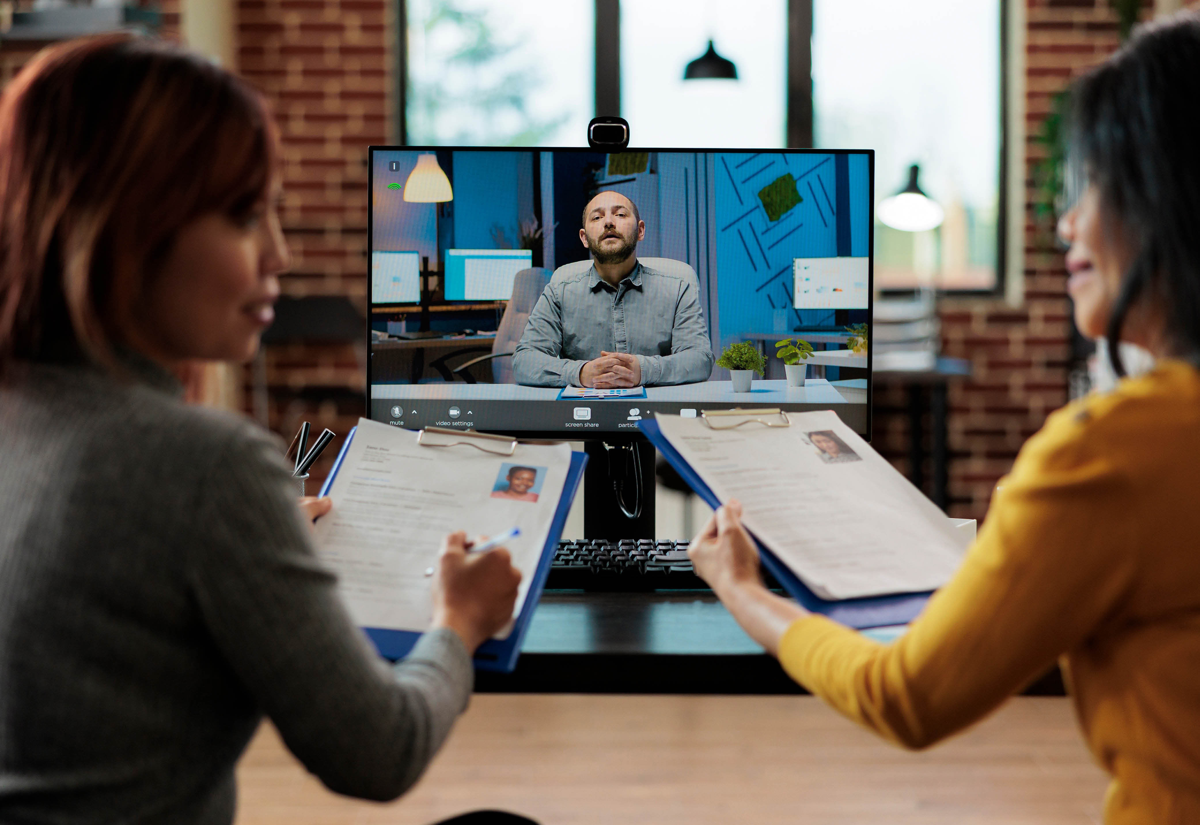 Three people having a virtual meeting with each other.
