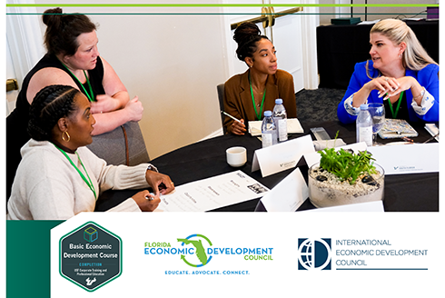 4 woman sit at a table during the bedc conference talking. With the BEDC logos below