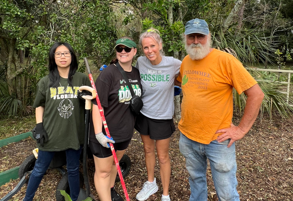 Ly Do, Jordon Wilson, Stephanie Arthur, and Craig Huegel (left to right) standing together for a group photo at the USF Botanical Gardens.