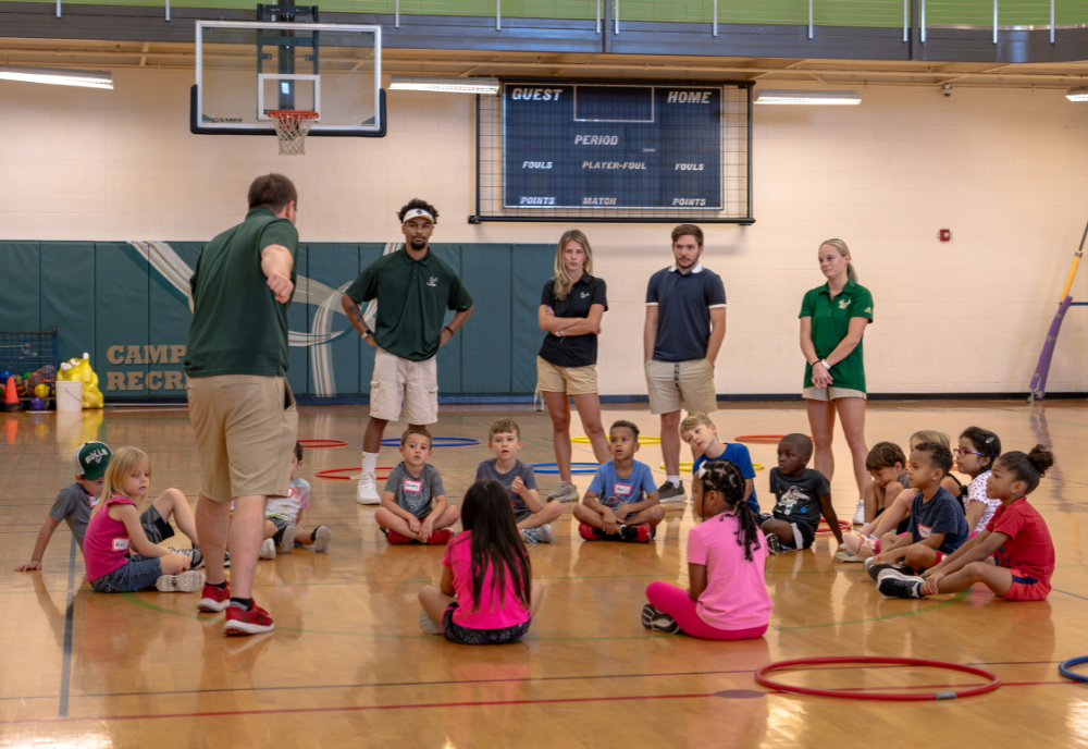 Craig Nieman and four USF Physical Education students teaching a free homeschool PE class.