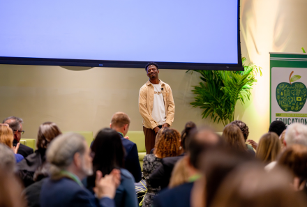 Charles Clark receiving a standing ovation after his keynote at Education in Action