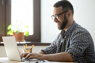 Man with laptop at home