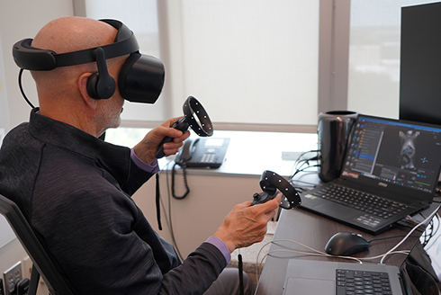 George Spirou, medical engineering professor, using syGlass VR software to study images of neurons through an immersive experience that allows them to see the brain in great detail. | Photo by: Cassidy Delamarter