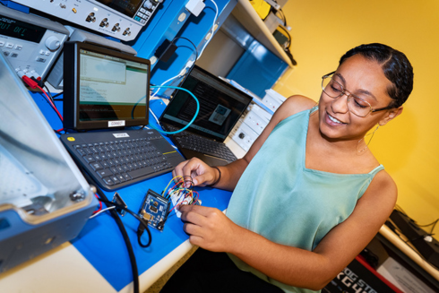 Deziree Price, a former intern at the USF Institute of Applied Engineering, works on a Basic Internet of Things Starter Kit (BISKit).