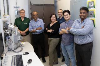 USF engineering professors posing in clean room