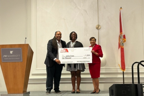 Image of Gelisa Evans Receiving award on Stage at JW Marriott