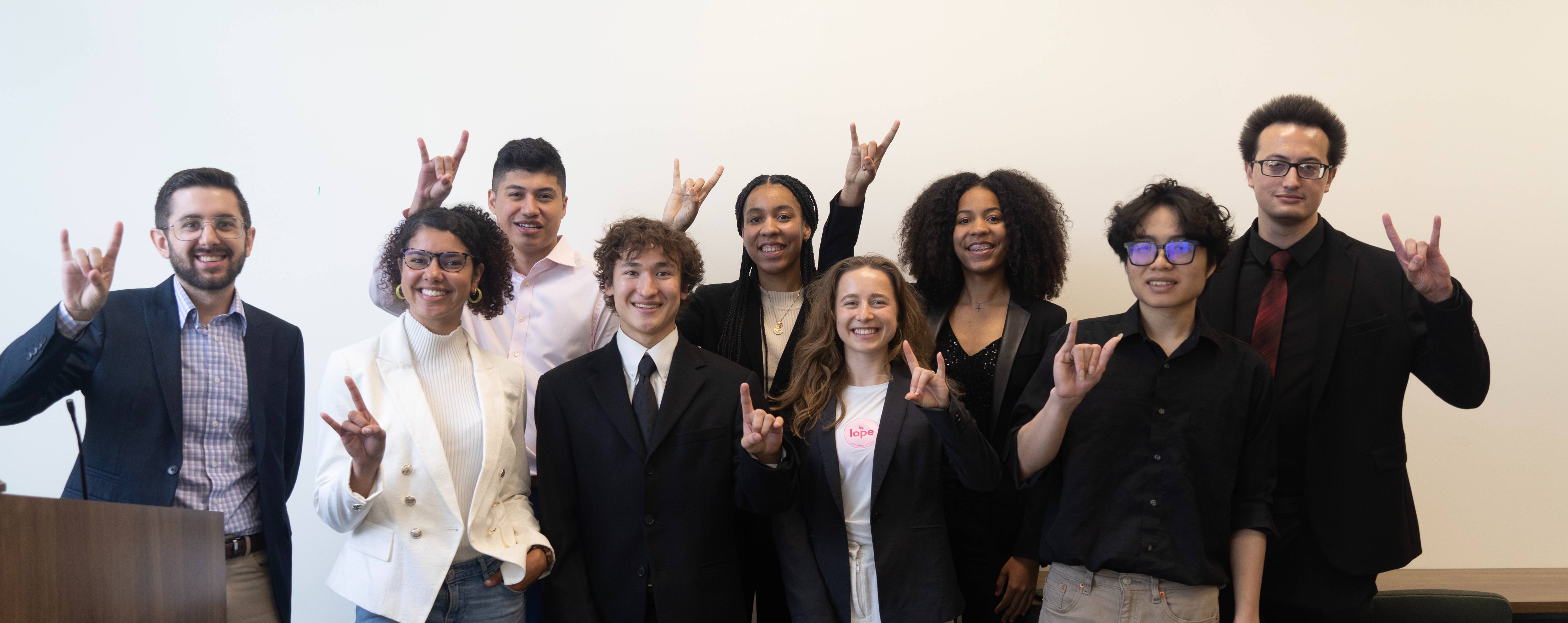 student innovation incubator student cohort in suites making the USF Bulls sign with their hands