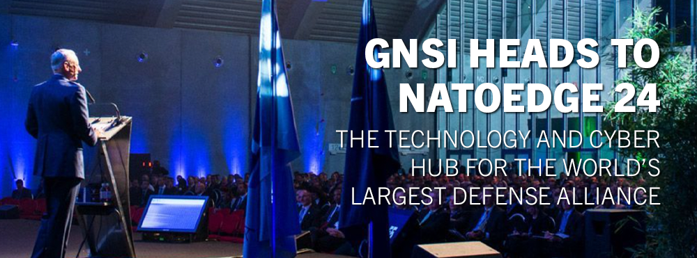 Image of Conference with overlaid text stating "GNSI Heads to NATOEdge 24: The Technology and Cyber Hub for the World's Larest Defense Alliance"