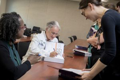 Dr. Lockwood signing textbook