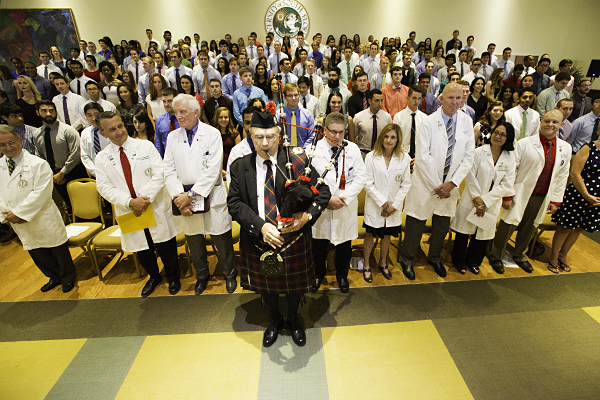 Dr. Greg Nicolosi playing the bagpipe as the 2015 ceremony begins.