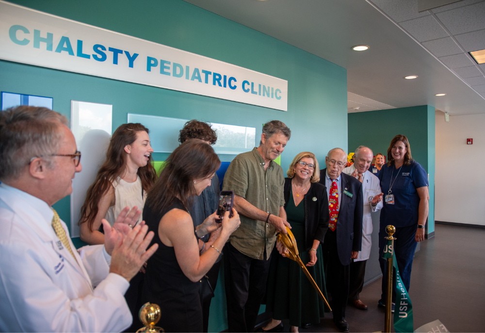 Cutting the ribbon to officially designate the Chalsty Pediatric Clinic