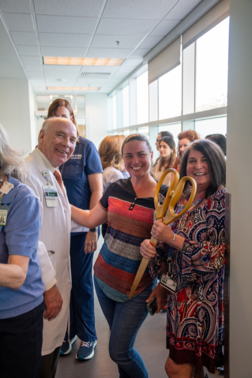 Health care providers and staff gathered for the ribbon-cutting