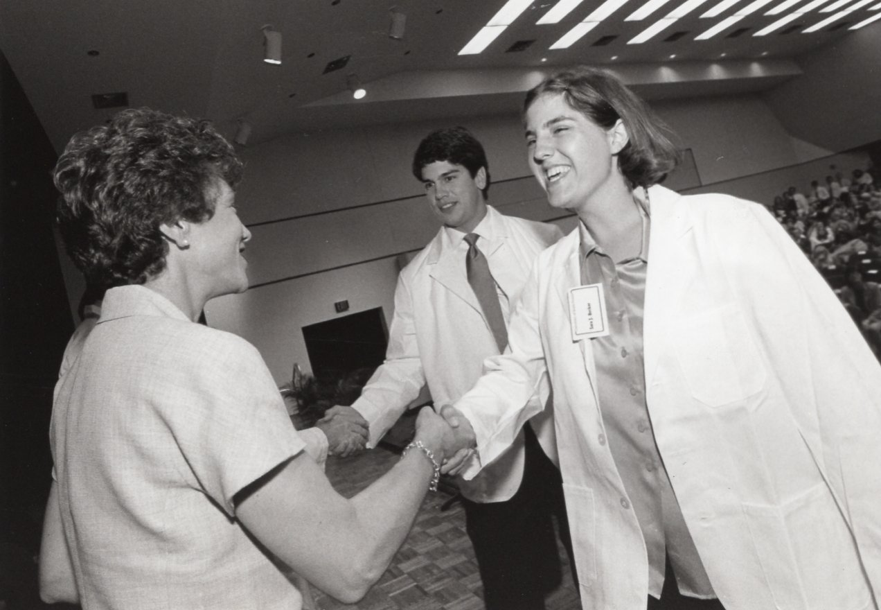 USF President Judy Genshaft congratulates medical student at the 2001 white coat ceremony.