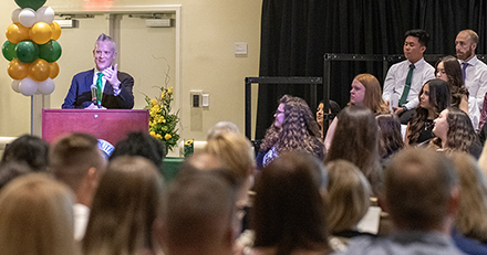 Keynote speaker talks in front of a large crowd.