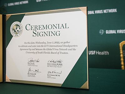 A piece of white and green paper with the USF seal with signatures 
