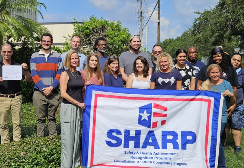 Tintometer employees gather to receive the SHARP award, underscoring the company’s dedication to workplace safety.