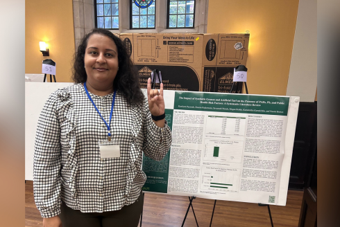 Researcher in front of a poster