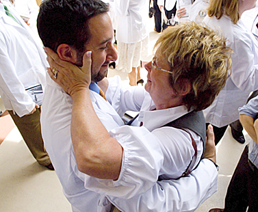 A congratulatory hug at the 2008 white coat ceremony.