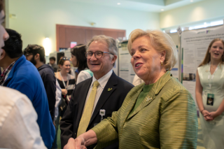 President Law and Dr. Lockwood looking at a research poster