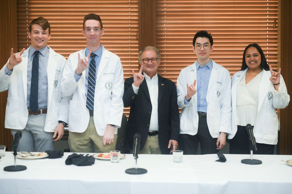 A group of four MD/PhD students with Dr. Charles J. Lockwood