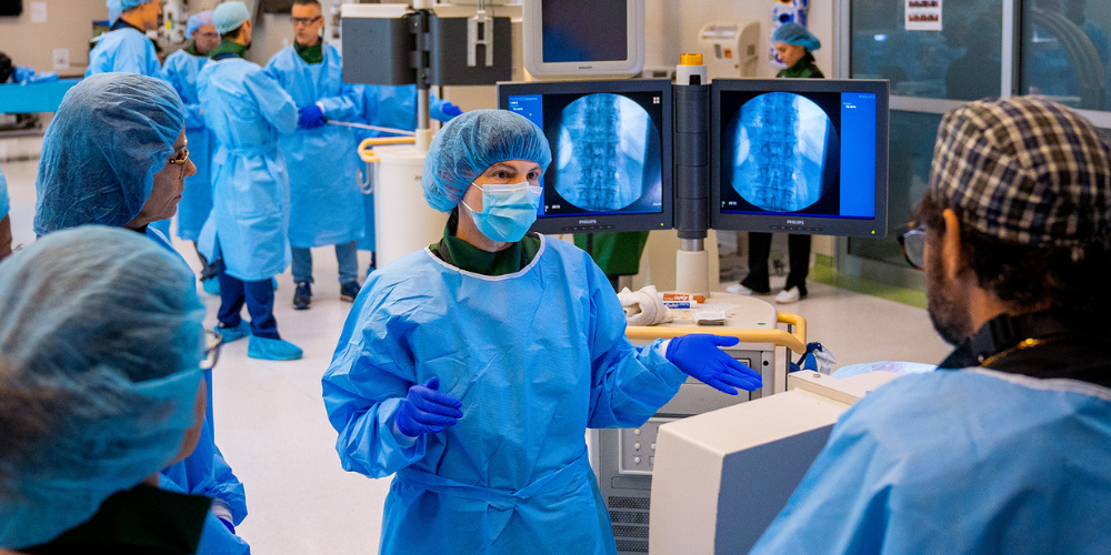 Lisa Pearson directing fellows in the operating room