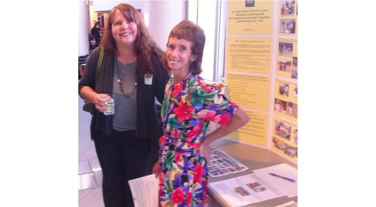 two women in front of poster presentation