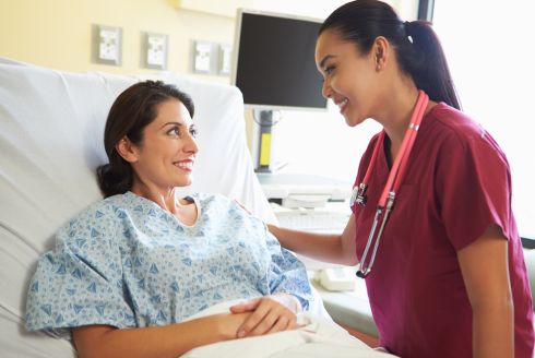 hispanic women in hospital bed and nurse