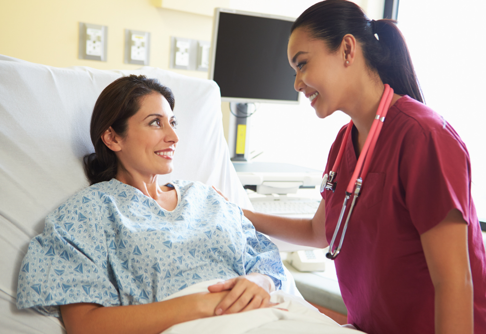 hispanic women in hospital bed and nurse