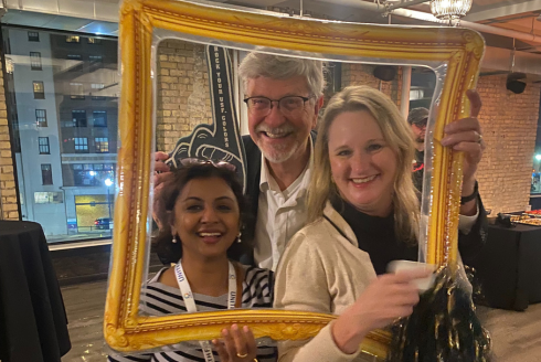 three people posing in a frame