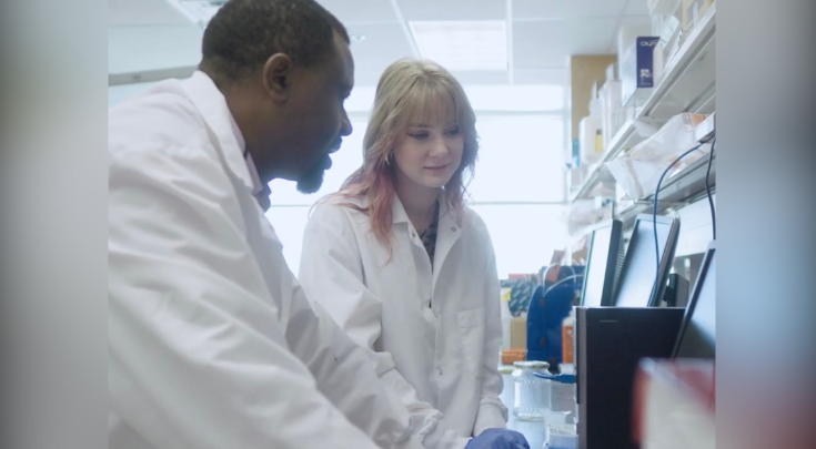 two people wearing lab coats in a lab